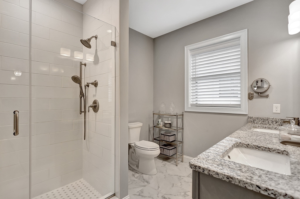 24 Del Ray Drive, Unit 25 Windham, NH 03087 - Photo 23 of 30 a bathroom with a granite countertop sink toilet and shower