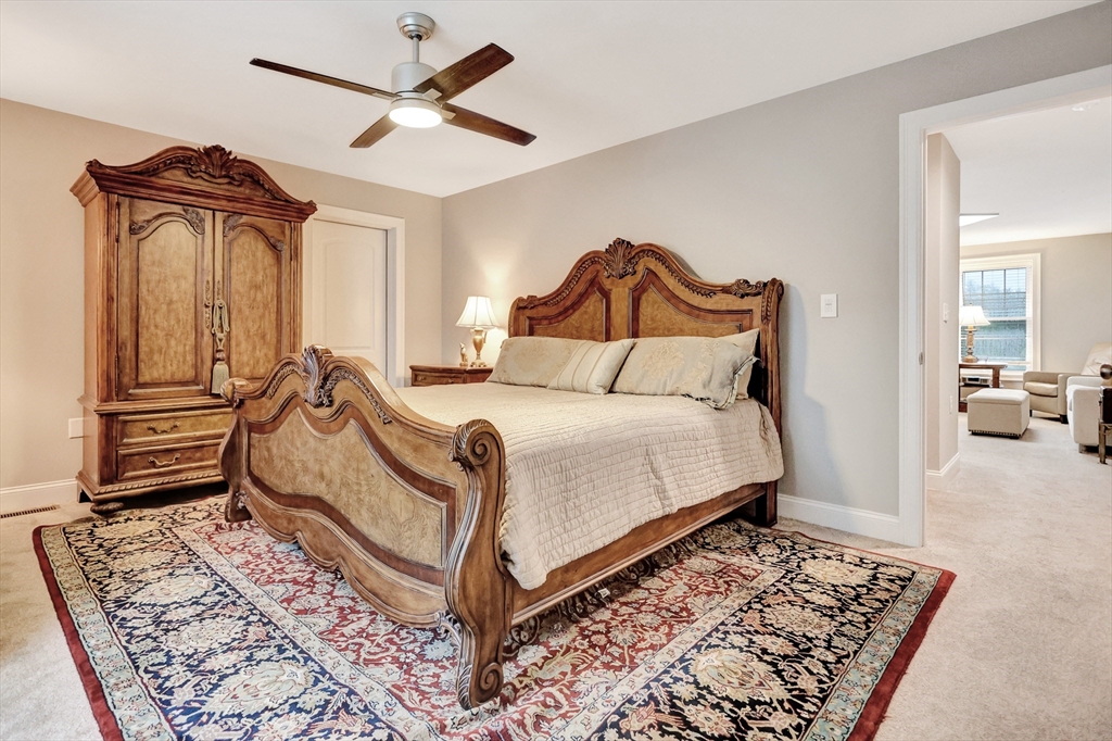 24 Del Ray Drive, Unit 25 Windham, NH 03087 - Photo 25 of 30 a bedroom with a bed and a chandelier