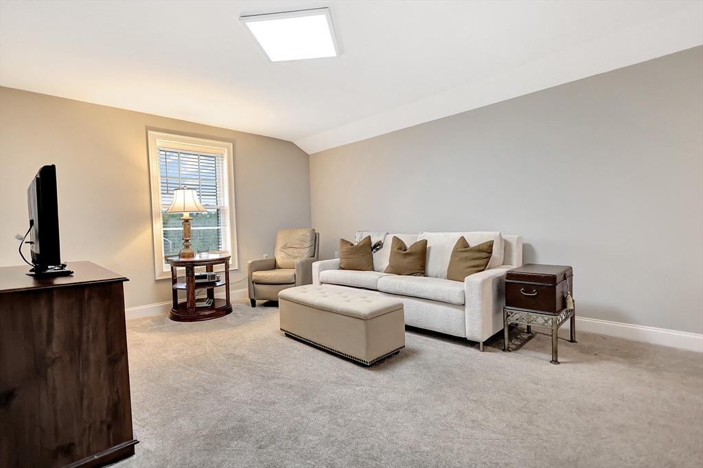 24 Del Ray Drive, Unit 25 Windham, NH 03087 - Photo 26 of 30 a living room with furniture and a flat screen tv