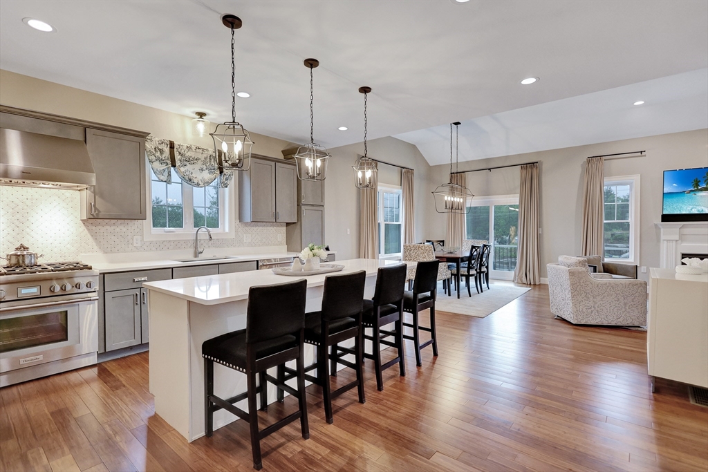 24 Del Ray Drive, Unit 25 Windham, NH 03087 - Photo 4 of 30 a large kitchen with a table and chairs