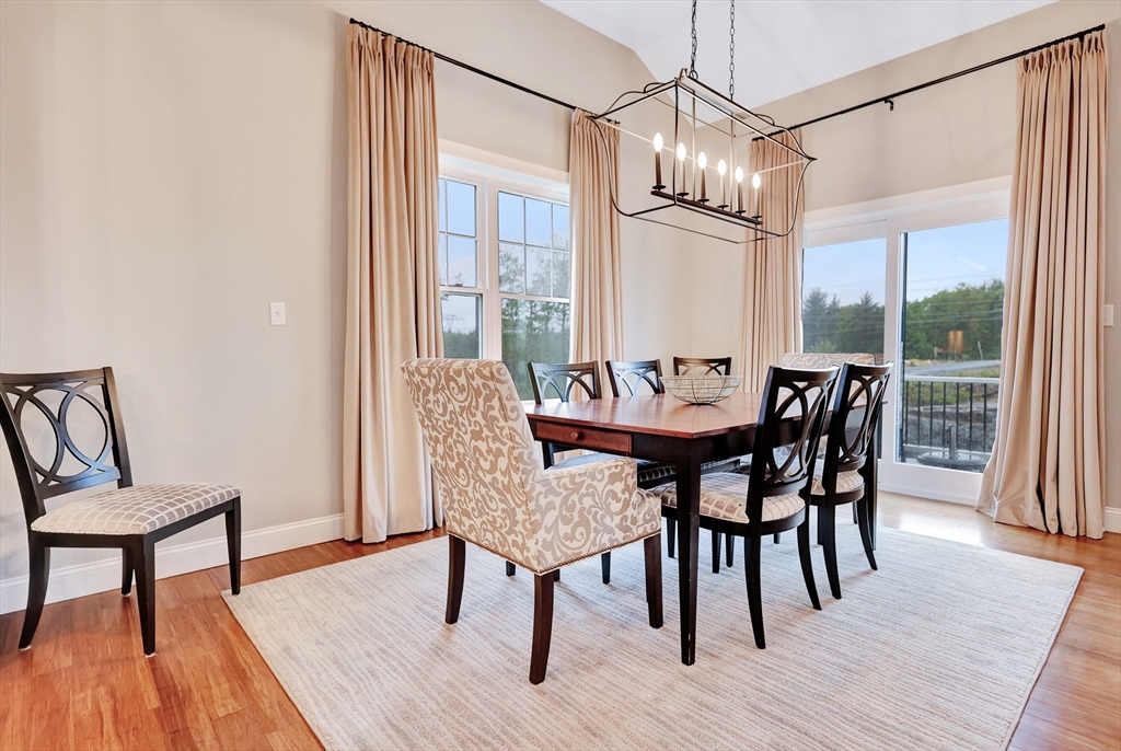 24 Del Ray Drive, Unit 25 Windham, NH 03087 - Photo 10 of 30 a view of a dining room with furniture window and wooden floor