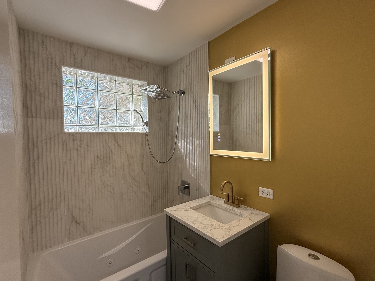 881 East Thacker Street Des Plaines, IL 60016 - Photo 12 of 17 a bathroom with a sink a toilet and shower