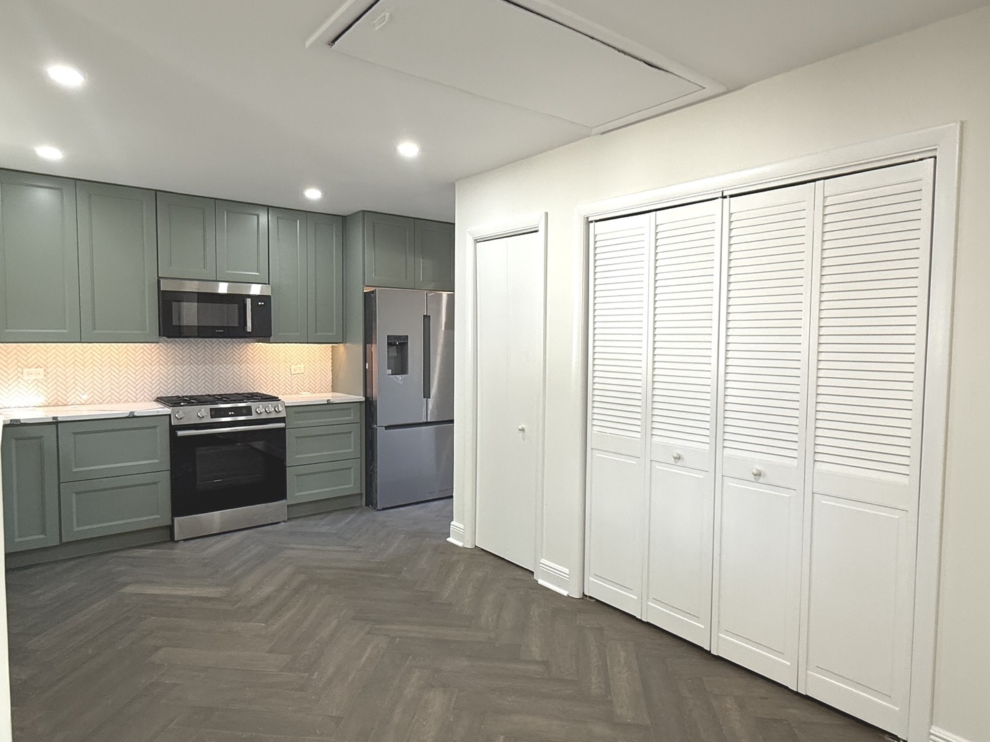 881 East Thacker Street Des Plaines, IL 60016 - Photo 8 of 17 a large kitchen with stainless steel appliances granite countertop a refrigerator and a sink