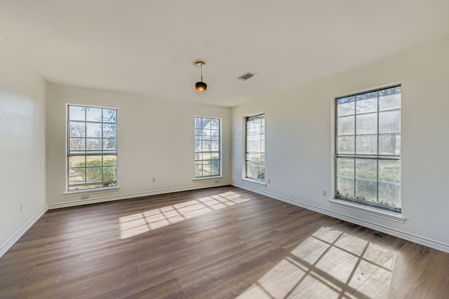 34411 Fulshear Farms Road Fulshear, TX 77441 - Photo 7 of 29 an empty room with wooden floor and windows