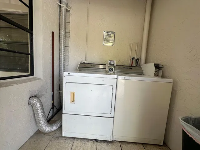 a view of a house with a big yard and large trees
