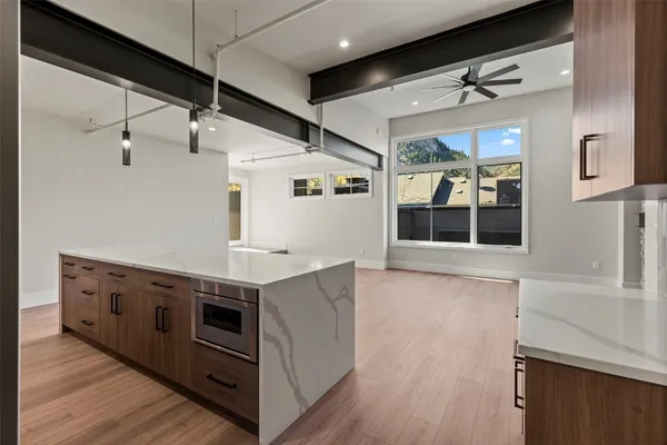 a kitchen with stainless steel appliances granite countertop a stove and a microwave