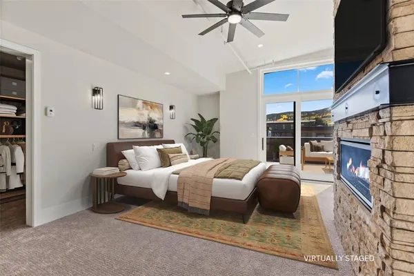 an empty room with closet and a chandelier fan