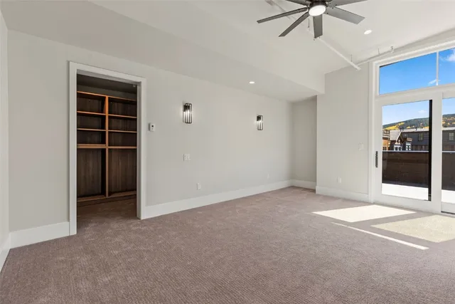 a view of an empty room with a fireplace and a window
