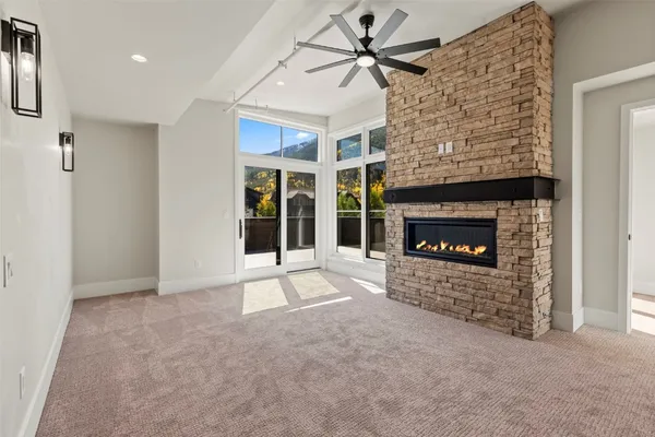 a view of an empty room with a fireplace and a window