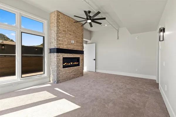 a view of an empty room with a ceiling fan