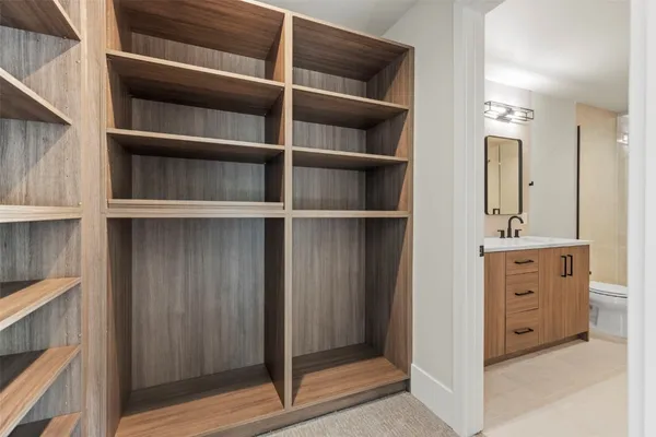 a bathroom with a double vanity sink toilet mirror and shower