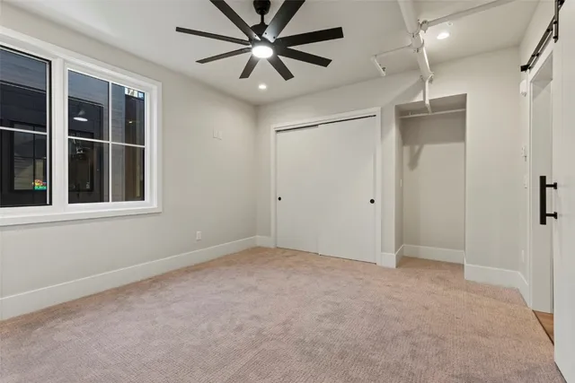 a view of a hallway with a ceiling fan