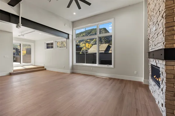 a view of an empty room with a fireplace and a window