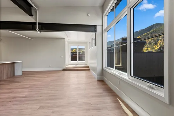 a view of an entryway with wooden floor