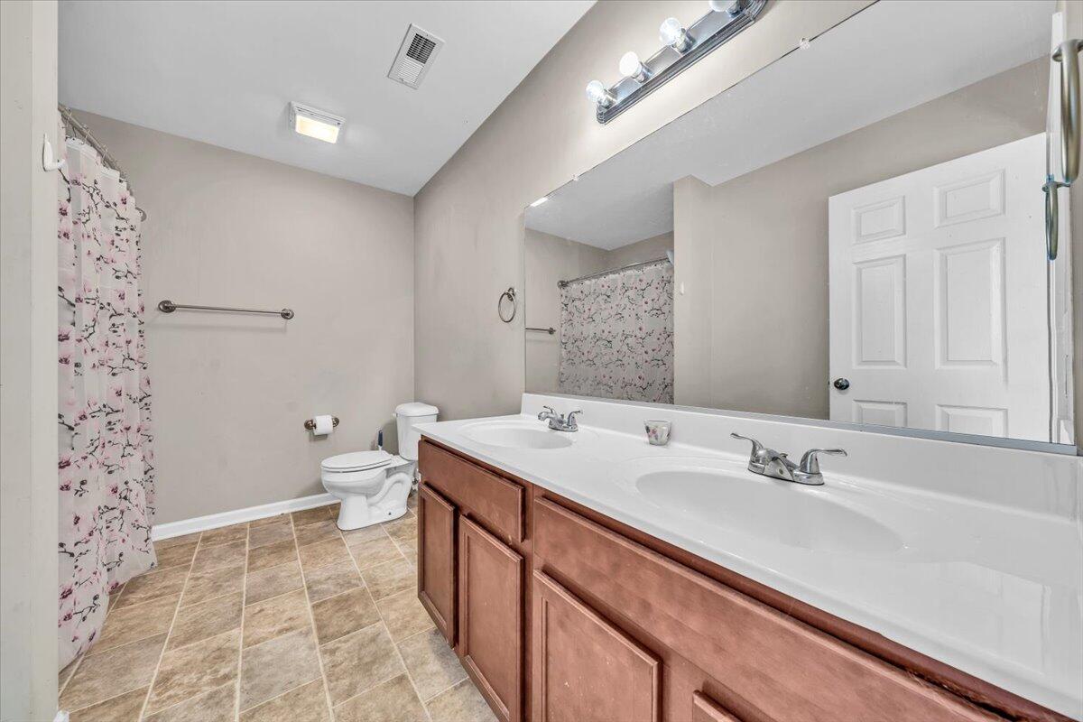 563 Kemp Ford Road Union Hall, VA 24176 - Photo 17 of 38 a spacious bathroom with a sink a toilet a shower and a mirror