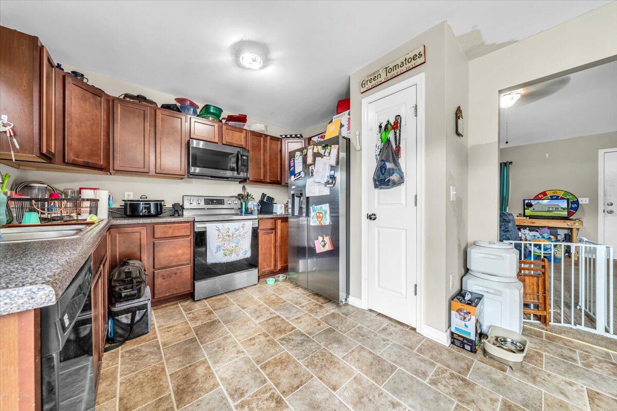 563 Kemp Ford Road Union Hall, VA 24176 - Photo 7 of 38 a kitchen with stainless steel appliances granite countertop a refrigerator and a sink
