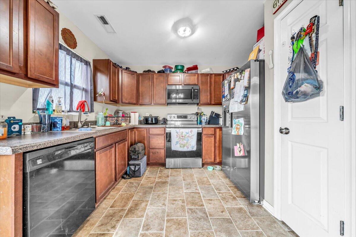 563 Kemp Ford Road Union Hall, VA 24176 - Photo 8 of 38 a kitchen with stainless steel appliances granite countertop a refrigerator and a stove top oven