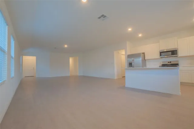 a kitchen with stainless steel appliances a refrigerator a sink and a stove