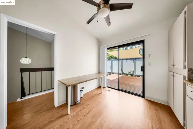 a view of a room with wooden floor and windows