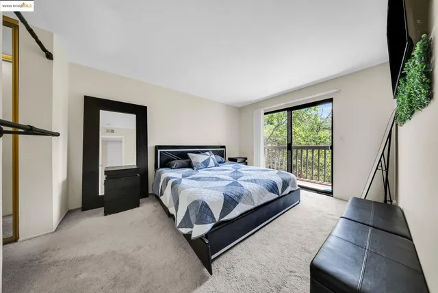 a bedroom with a bed and a large window