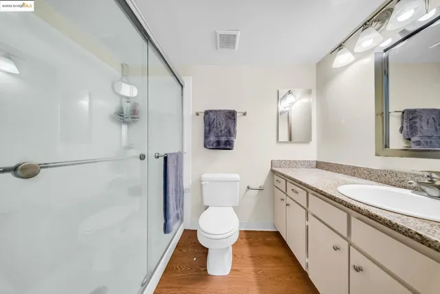 a bathroom with a toilet sink and a mirror