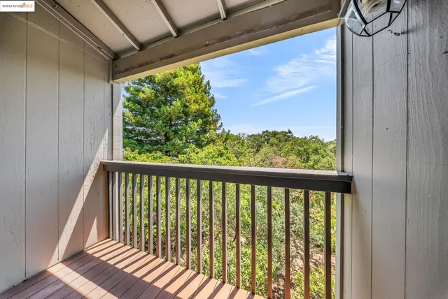 a view of a balcony with wooden floor