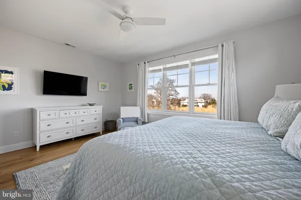 a bedroom with a bed lamp and a window