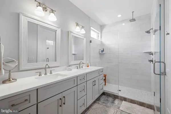 a bathroom with a toilet a sink a tub and mirror