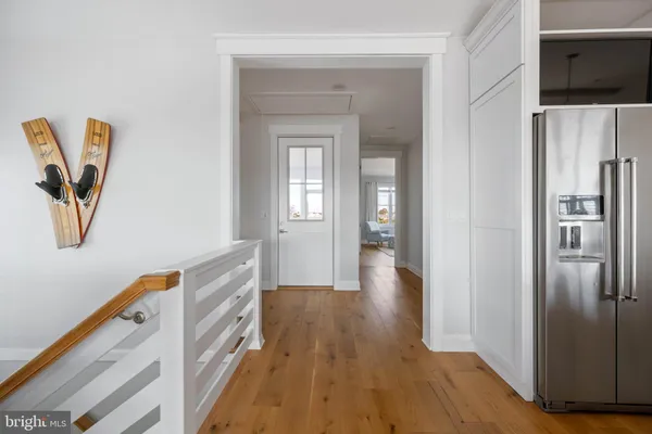 a view of a livingroom with wooden floor and white walls