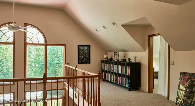 a living room with furniture a bookshelf and a book shelf