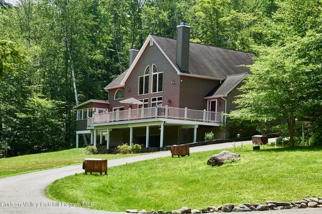 a front view of a house with a yard table and chairs