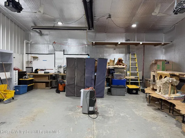 an aerial view of residential house with outdoor space and trees all around