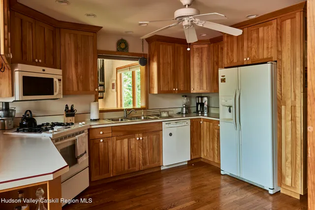 a kitchen with wooden cabinets and refrigerator