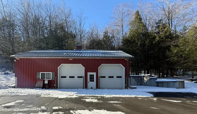 a front view of a house with a yard table and chairs