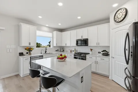 a living room with furniture a large window and a flat screen tv