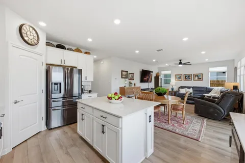 a kitchen with stainless steel appliances a stove a refrigerator a sink a stove and cabinets