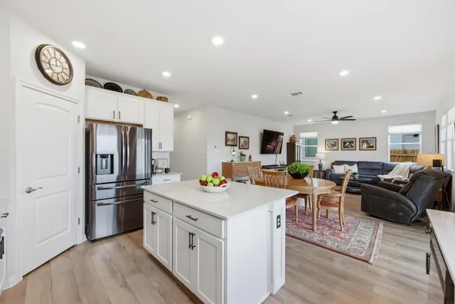 a kitchen with stainless steel appliances a stove a refrigerator a sink a stove and cabinets