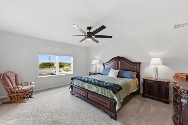 a view of a livingroom with furniture and a ceiling fan