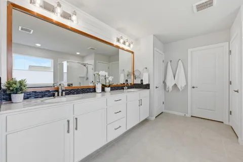 a spacious bedroom with a bed and window