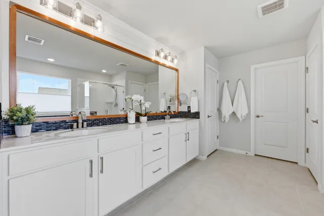 a spacious bedroom with a bed and window