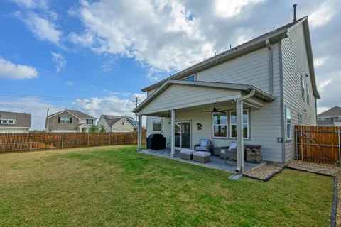 a view of a porch with furniture and a yard