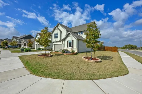a view of a house with a backyard