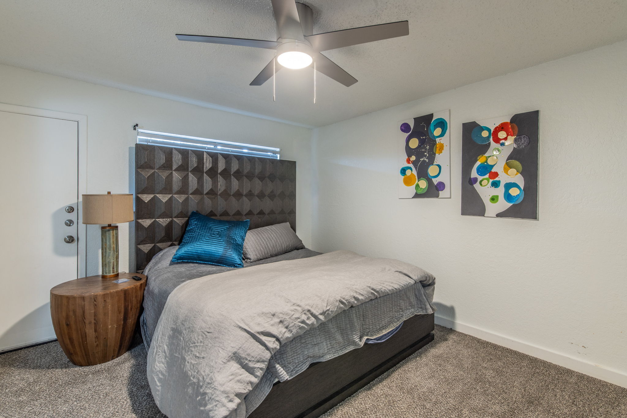 1008 Milford Way Austin, TX 78745 - Photo 30 of 40 Carpeted room featuring a modern ceiling fan with integrated lighting, a window with horizontal blinds, and a white door with silver-finish hardware