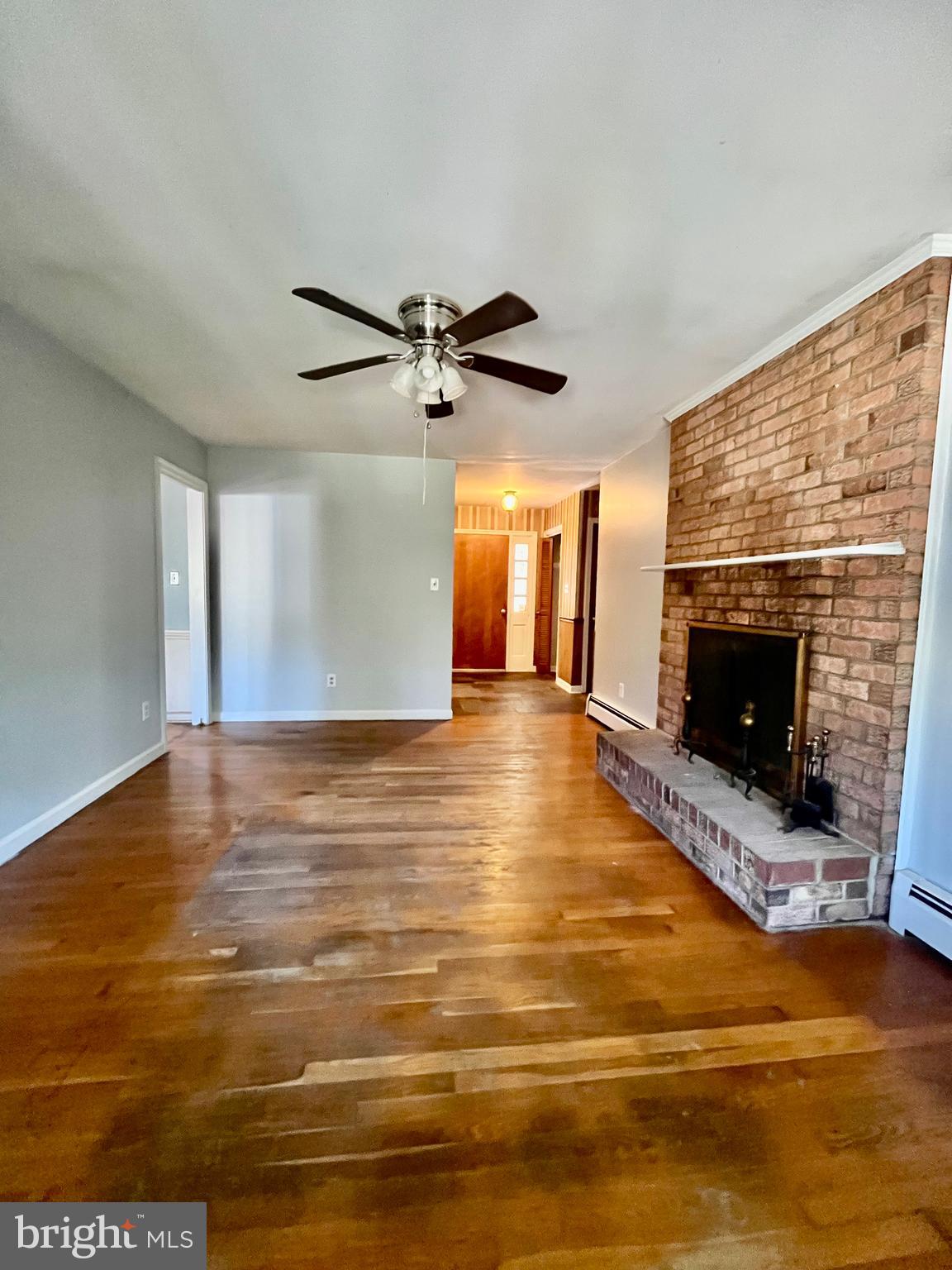 4302 Baxter Road Prince George, VA 23875 - Photo 46 of 78 a view of an empty room with a fireplace and wooden floor
