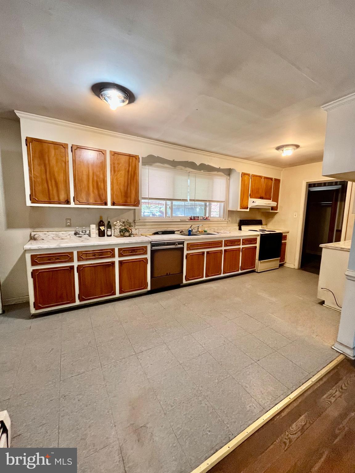 4302 Baxter Road Prince George, VA 23875 - Photo 54 of 78 a large kitchen with stainless steel appliances wooden cabinets and a counter top space