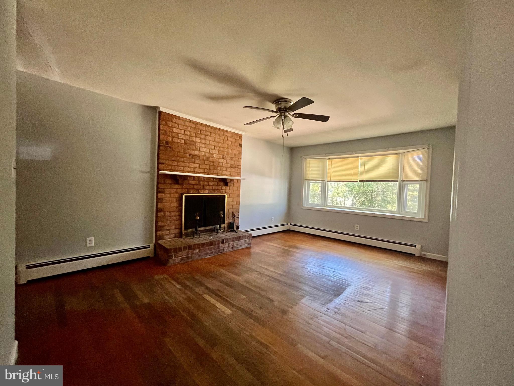 4302 Baxter Road Prince George, VA 23875 - Photo 56 of 78 an empty room with windows fireplace and fans