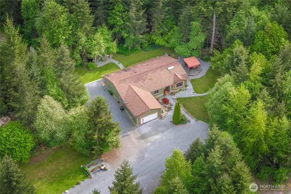 a kitchen with stainless steel appliances granite countertop a refrigerator a sink dishwasher a stove and white cabinets with wooden floor