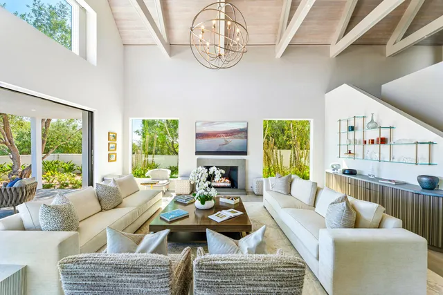 a living room with furniture and kitchen view