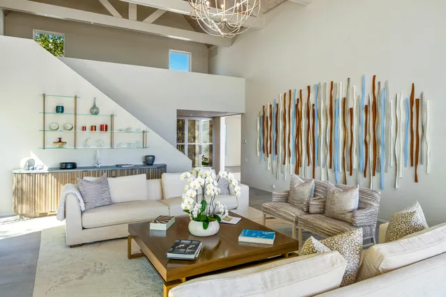 a living room with furniture and a floor to ceiling window