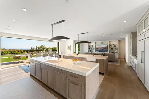 a spacious bathroom with double vanity a large mirror a bathtub and a shower